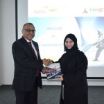 Eugene Mayne hands over the first copy of the Tristar Sustainability Report to Habiba Al Marashi