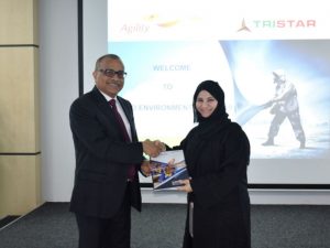 Eugene Mayne hands over the first copy of the Tristar Sustainability Report to Habiba Al Marashi