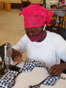 A seamstress sewing a face mask