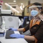 Guest Service Agent at Etihad Airways Medical Centre wearing the face mask