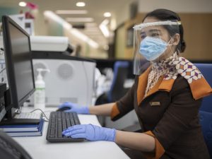 Guest Service Agent at Etihad Airways Medical Centre wearing the face mask