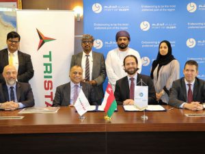 Eugene Mayne (second left, seated) with other officials at  the deal signing ceremony