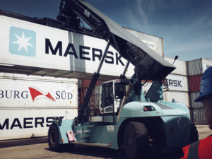 Maersk containers being stacked at a port