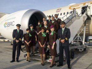 Etihad Airways crew pose in front of an aircraft